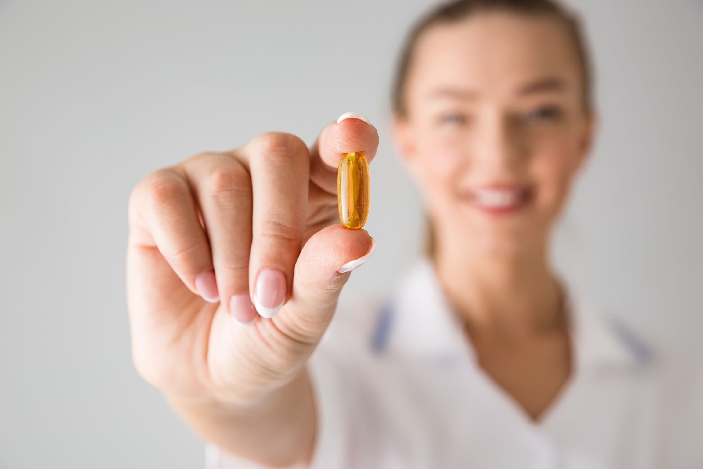 WomanHolding Pill Vitamin